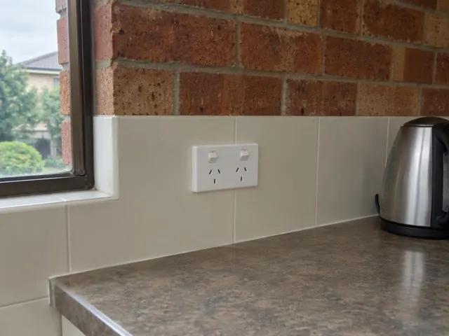 Double power point fitted in a tiled kitchen splashback above a benchtop in Castle Hill